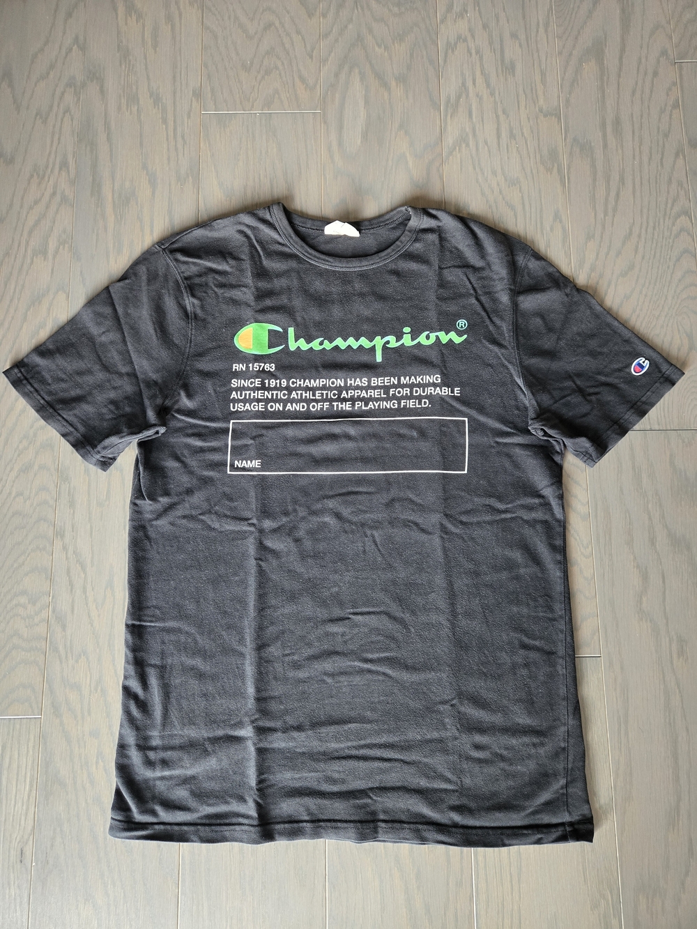 Champion Black Short‑Sleeve Graphic Tee with Neon Green Logo
